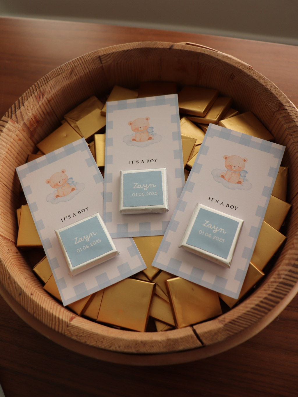 baby shower its a boy chocolate favour cards with 'It's a Boy' text in a wooden basket