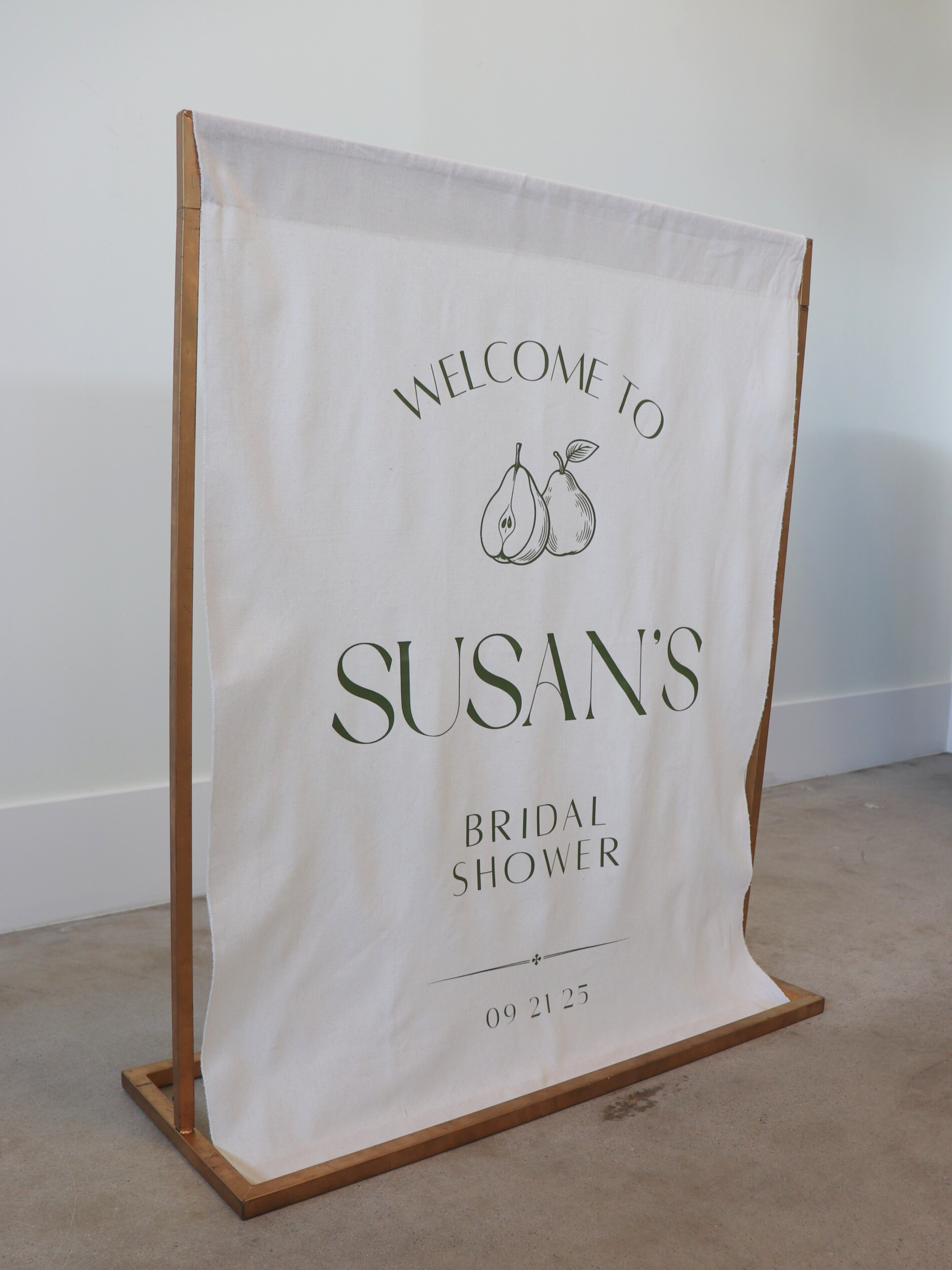 Bridal shower welcome sign on a stand with 'Welcome to Susan's Bridal Shower' text.