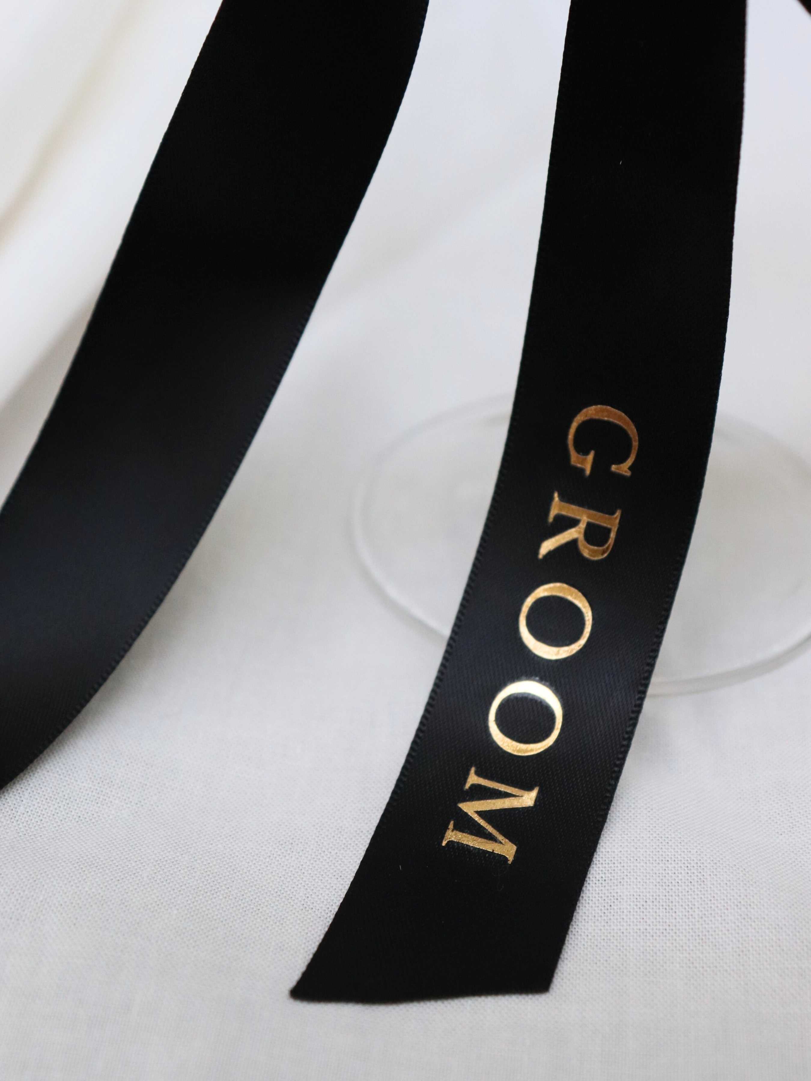 Black ribbon with 'GROOM' text on a white background. groom gold text black personalized ribbon for wedding