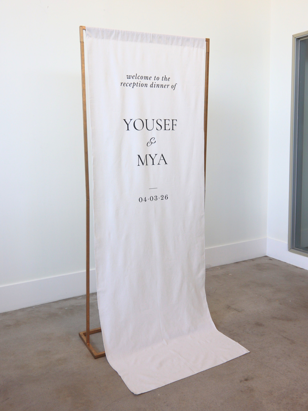 linen welcome sign with gold stand angles right